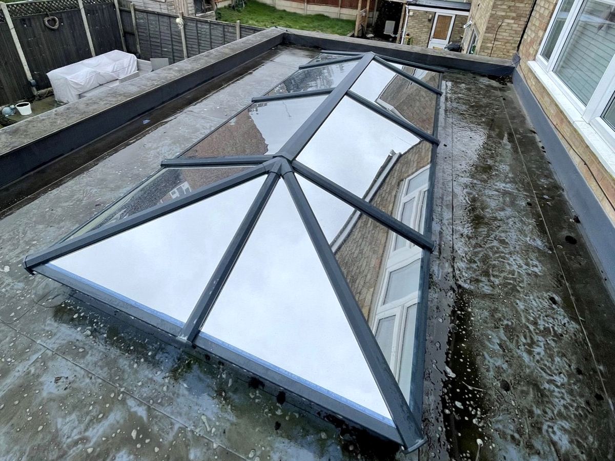 Solar film on a large roof lantern with grey frames on a flat roof